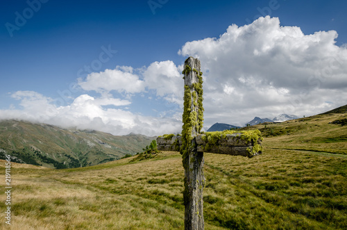 Wooden cross standing in the mountains