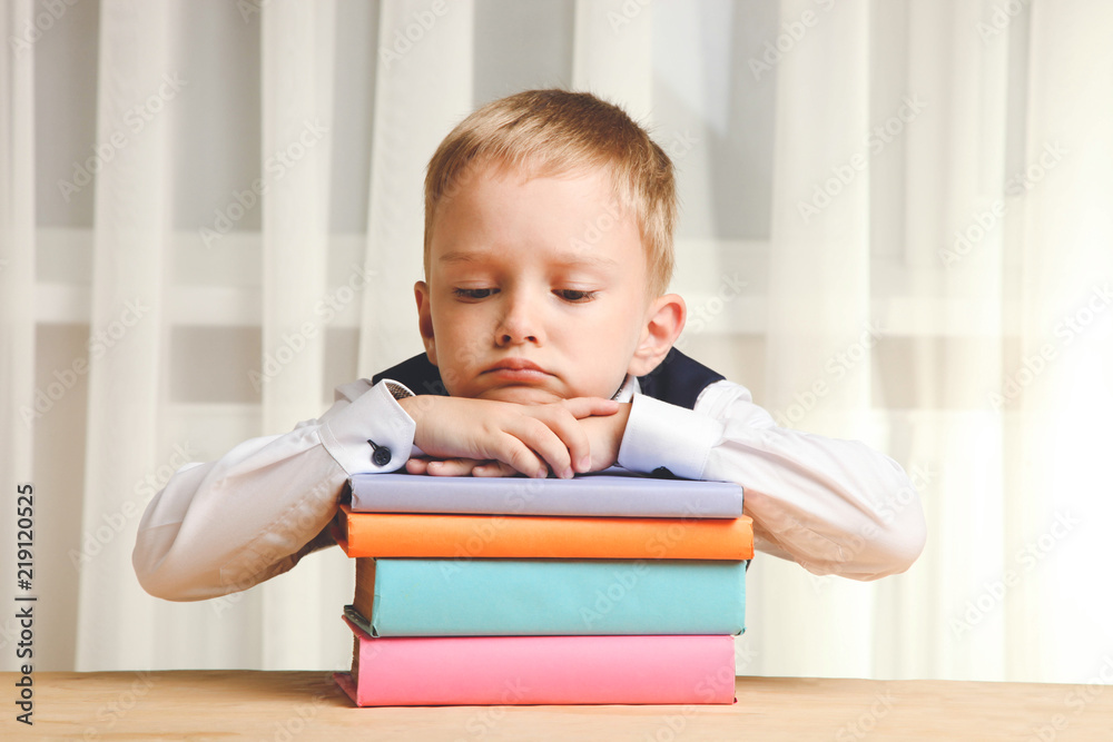 schoolboy asleep on books