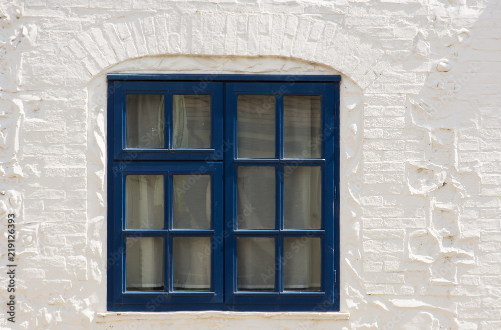 Blue window in white wall