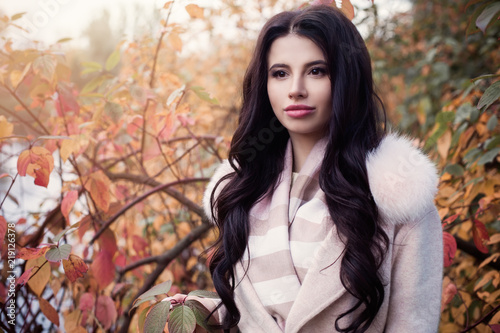 Perfect autumn woman with long hair and makeup outdoors