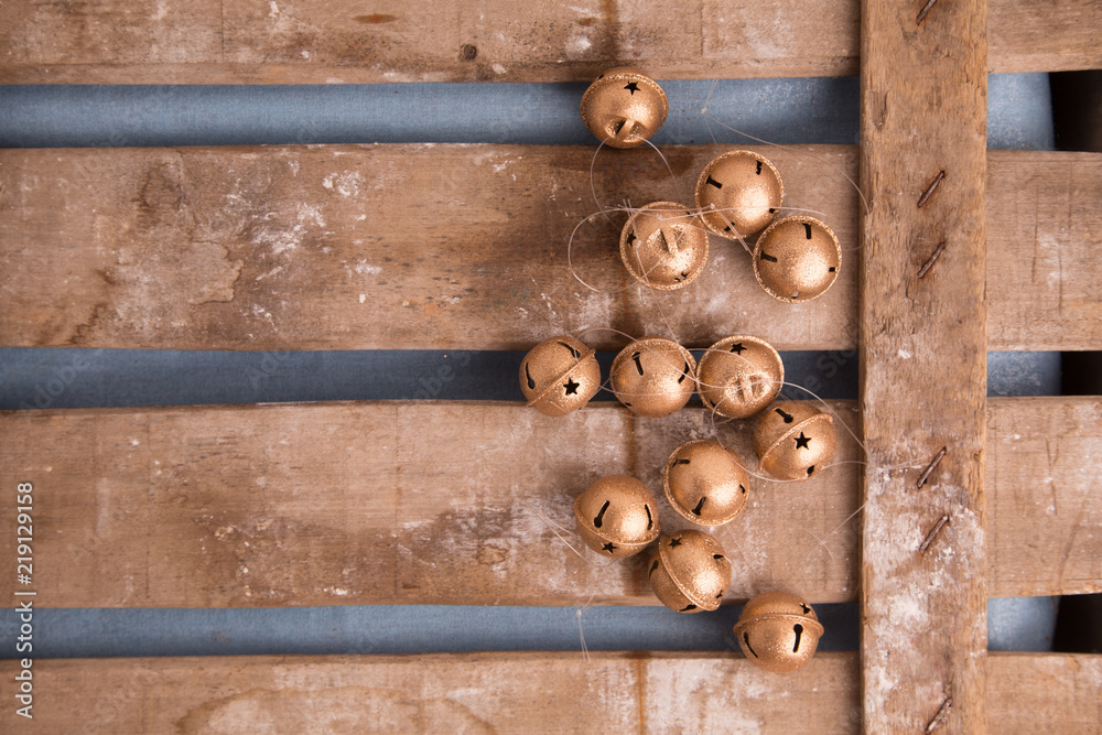 Christmas tree ornament jingle bells on wooden background