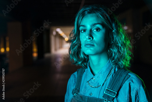 Portrait of a beautiful woman at night, wearing dungarees photo