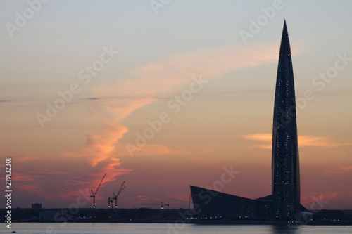 Sunset behind The Lakhta Centre, Gazprom Tower. Color clouds in the evening. Industrial city landscape.