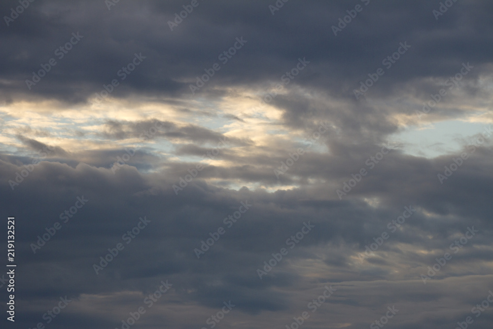 Dark gray clouds blue sky background. Cumulonimbus