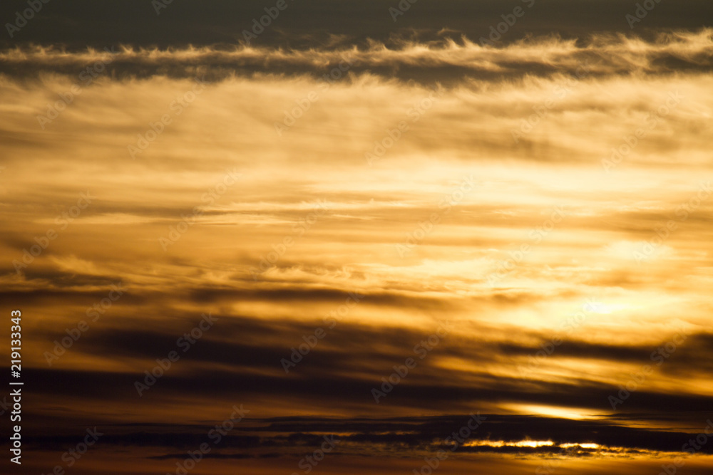 Sky clouds background. Cumulus red clouds in the sunset. Color clouds in the evening. Sky with a dark pastel colored background