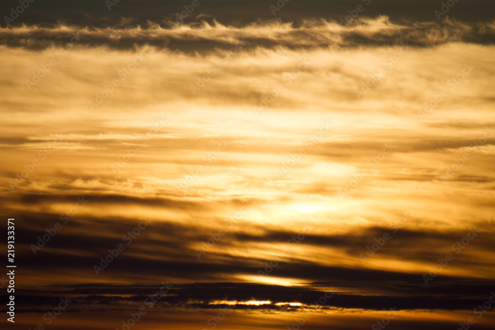 Sky clouds background. Cumulus red clouds in the sunset. Color clouds in the evening. Sky with a dark pastel colored background