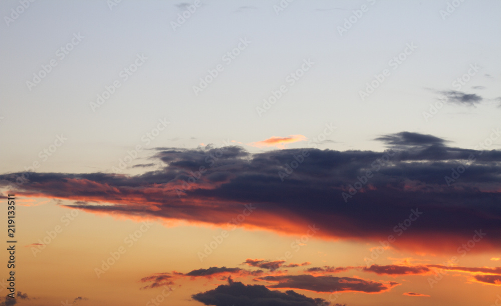 Sky clouds background. Cumulus clouds in the sunset. Color clouds in the evening. Sky with a pastel colored background