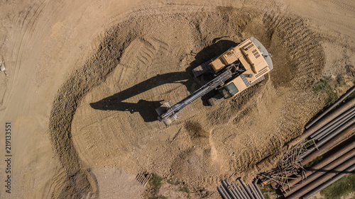 Aerial construction site with machinery. Top down view of city building site.