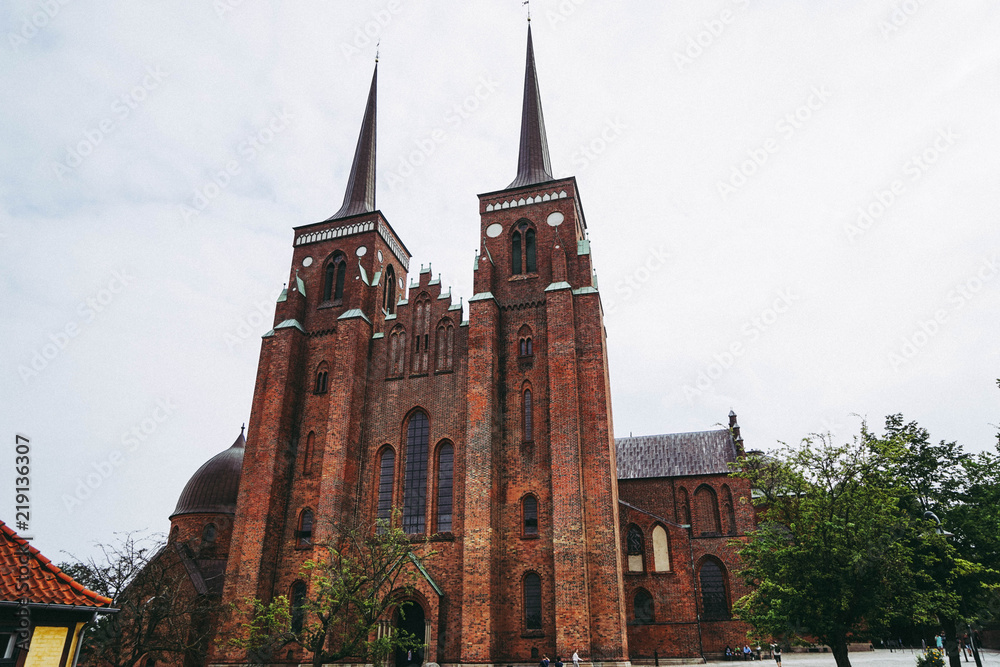 Roskilde Cathedral is a cathedral of the Lutheran Church of Denmark. The first Gothic cathedral to be built of brick, it encouraged the spread of the Brick Gothic style throughout Northern Europe Roskilde Cathedral is a cathedral of the Lutheran Church of Denmark. The first Gothic cathedral to be built of brick, it encouraged the spread of the Brick Gothic style throughout Northern Europe