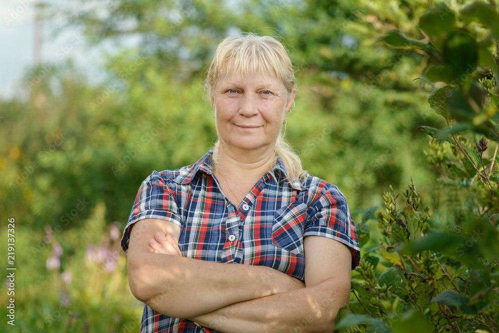 Portrait of a beautiful middle-aged woman outdoors. Selective focus. Portrait of a beautiful middle-aged woman outdoors. Selective focus.