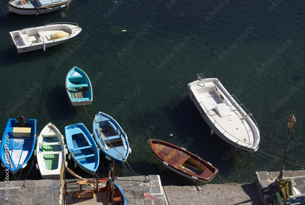 Arrangement of white and blue boats in the port and the blue sea Arrangement of white and blue boats in the port and the blue sea