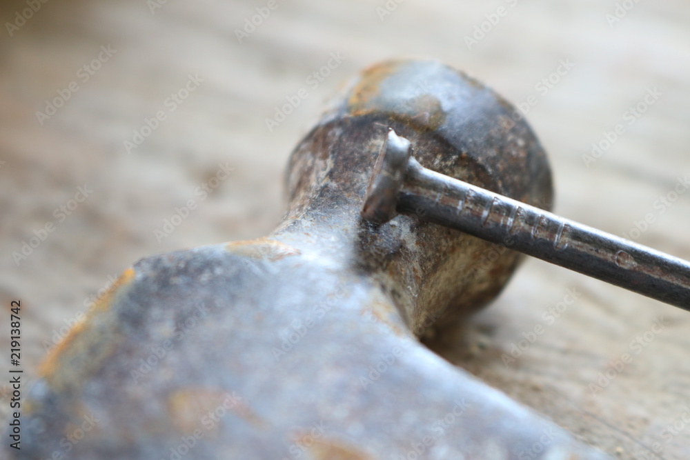 Spikes and hammers on a wooden table Spikes and hammers on a wooden table