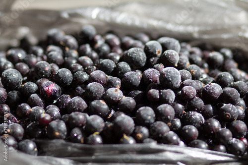 Currant black frozen. Ecological berries for desserts, smoothie or jam. Currant organic berries source of vitamins top view flat lay macro. photo