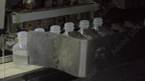 Sterilized clogged plastic bottles with medicine on the conveyor of Blow fill seal technology a manufacturing technique used to produce liquid-filled container on a medical or food industrial factory photo