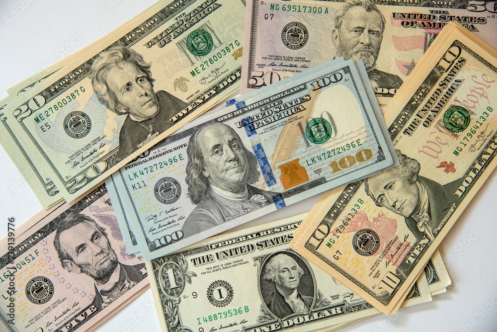 Scattered US currency banknotes Scattered US currency banknotes