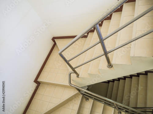 Beige or cream stair with the railing in condominium.