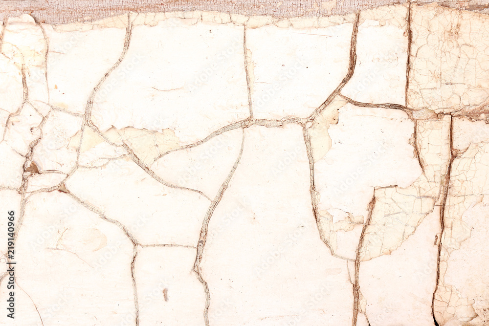 Obraz premium Old white painted piece of wood with cracked surface
