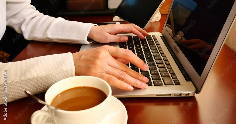 4k female sitting on the table,browing webpage on the laptop and ipad,keyboard input,hands typing on a computer keyboard,write article,writing report. 4k female sitting on the table,browing webpage on the laptop and ipad,keyboard input,hands typing on a computer keyboard,write article,writing report.