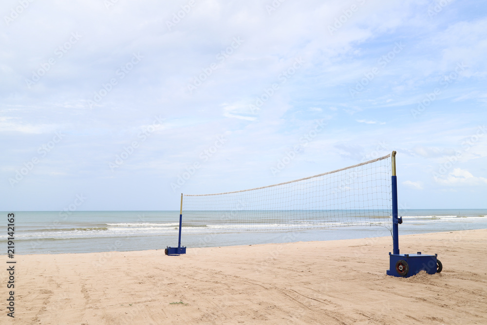 Closeup of volleyball net on sand beach with sea and cloudy sky background. Closeup of volleyball net on sand beach with sea and cloudy sky background.