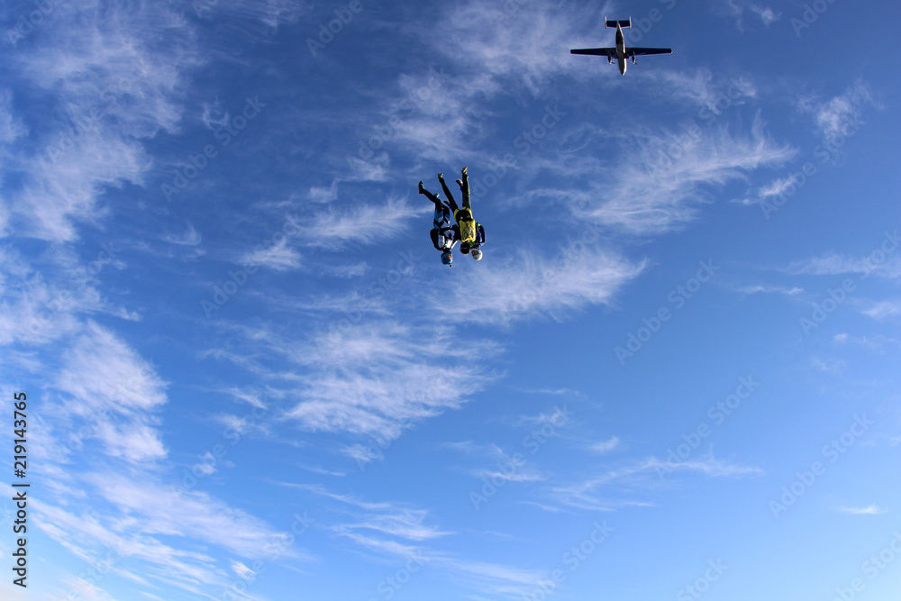 Two skydivers are falling in the amazing sky.