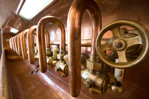 Close up of indusrial copper brewery taps