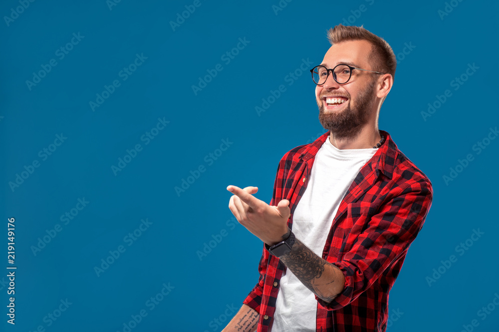 Emotional and people concept: young bearded man in checkered shirt. Hipster style. Emotional and people concept: young bearded man in checkered shirt. Hipster style.