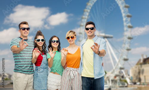 Photography travel, tourism and entertainment concept - group of happy smiling friends in su