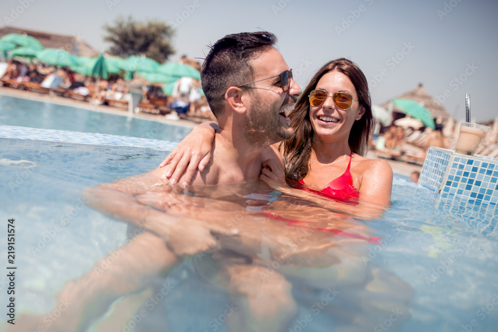 Fototapeta premium Couple having fun in swimming pool
