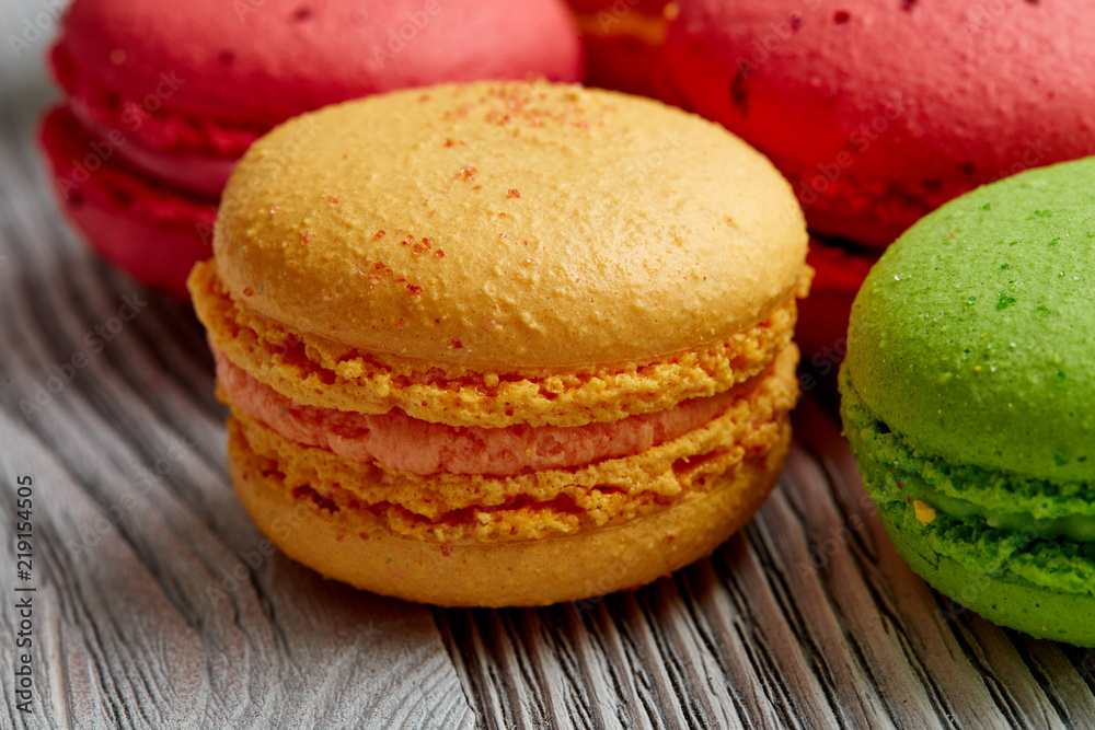 colorful macarons over   wood table. top view