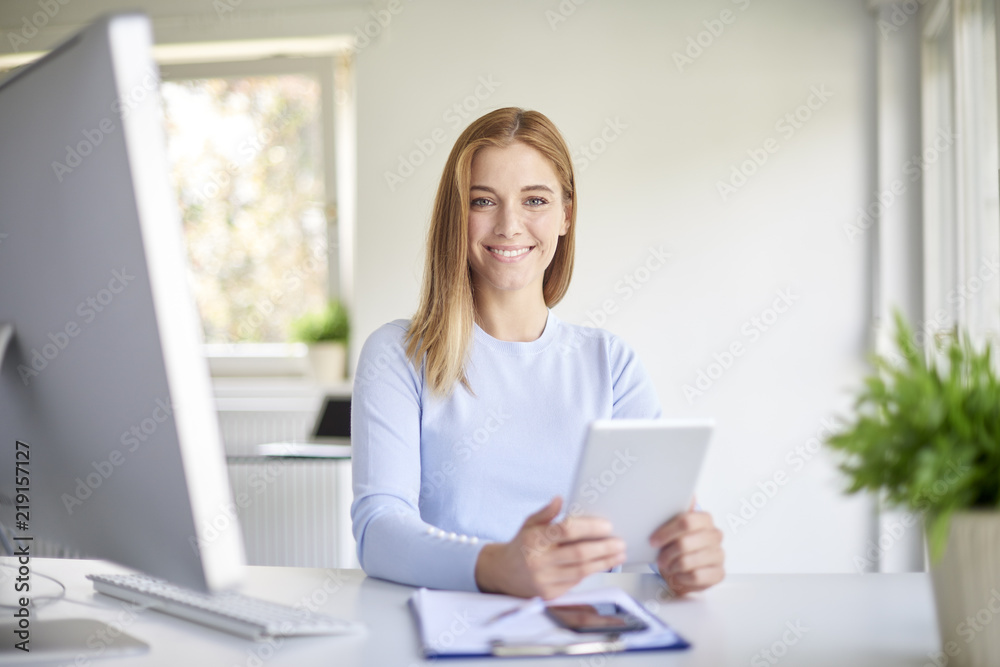Businesswoman using digital tablet while working in the office Businesswoman using digital tablet while working in the office