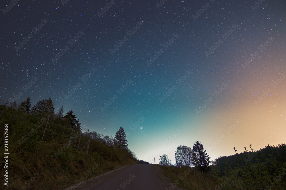 Starry night sky above the road in small town in Kysuce, Slovakia