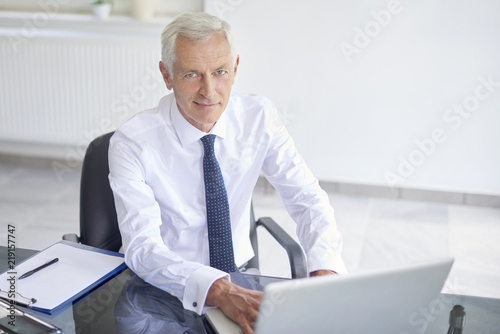 Senior businessman using his laptop