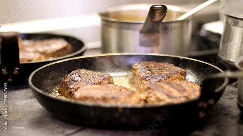 cooking fresh steak in kitchen