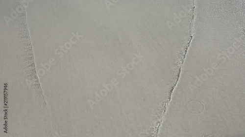 Sea waves over sand beach