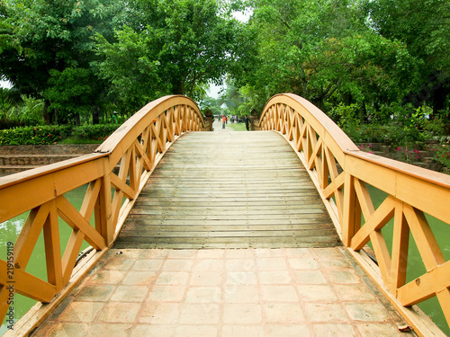 Wood bridge across the water in the park.