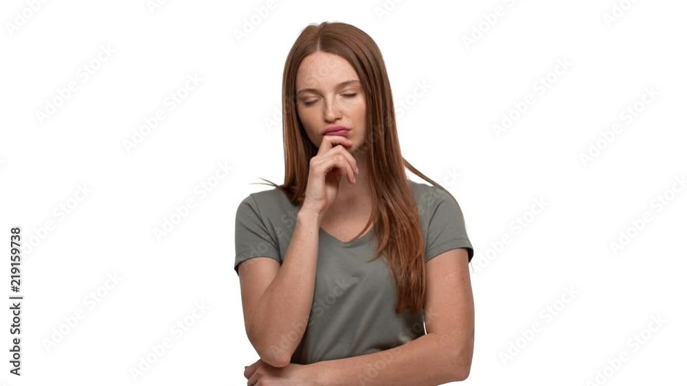 Portrait of concentrated hesitating woman 20s touching chin and thinking about important things or doubting, isolated over white background slow motion. Concept of emotions Portrait of concentrated hesitating woman 20s touching chin and thinking about important things or doubting, isolated over white background slow motion. Concept of emotions