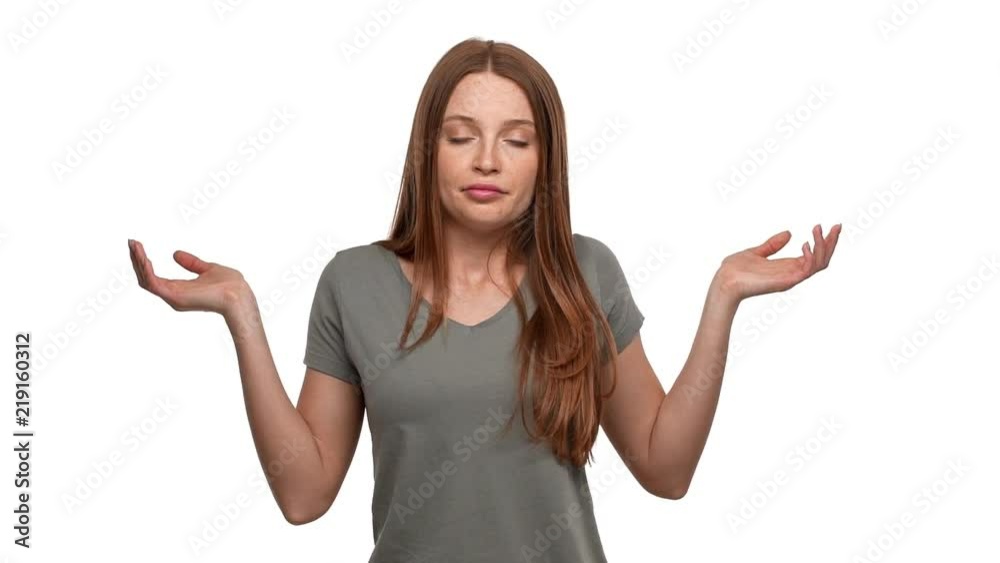 Portrait of indecisive woman 20s shrugging and throwing up hands