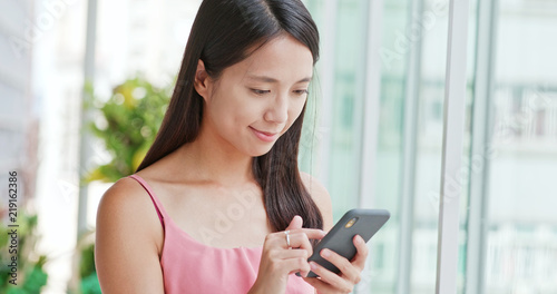 Woman use of smart phone for online inside shopping center