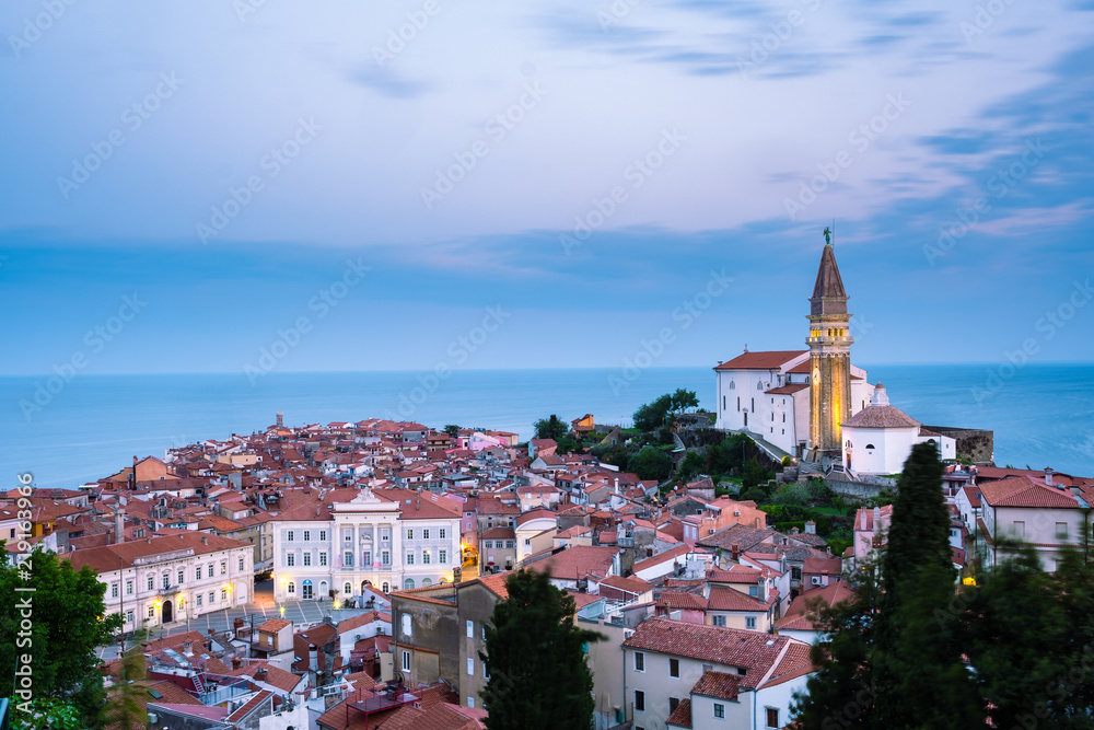 Morning cityscape of city of Piran, Slovenia with big dominant St. George's Parish Church and main square