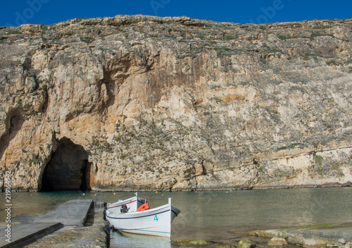 Inland sea in Dwejra, Gozo island(Malta). A small boat waiting for tourists to bring to Mediterranean sea.