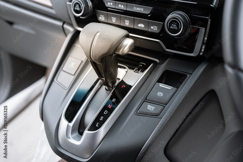 automatic gear stick of a modern car, car interior details.
Icon near a floor selection lever of car with automatic transmission gear shift.