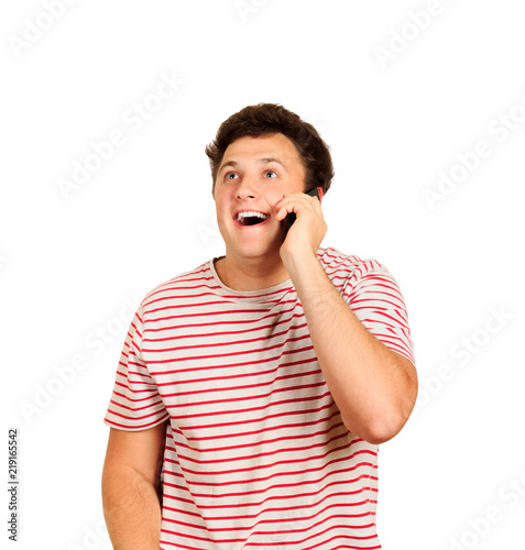casual young man talking on the phone and smiling . emotional guy isolated on white background