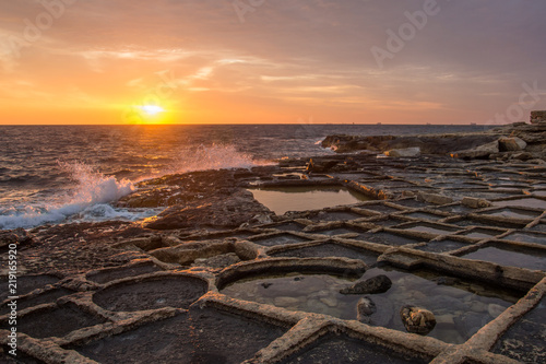 The sunrise over the salt pans, or salters, in Malta (Mediterranean sea)