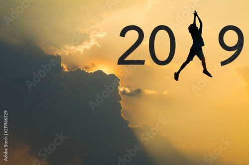 2019 number and people silhouette on Sunset light background