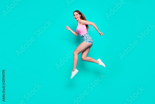 Fototapeta Naklejka Na Ścianę i Meble -  Full-size portrait of young student woman who laughs and runs th