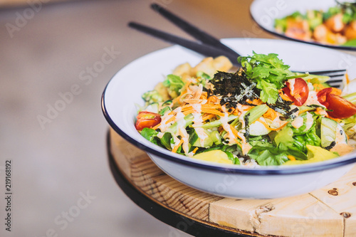 Green Goddess Buddha Bowl on wooden table. Healthy eating, food photography concept. Copyspace, horizontal