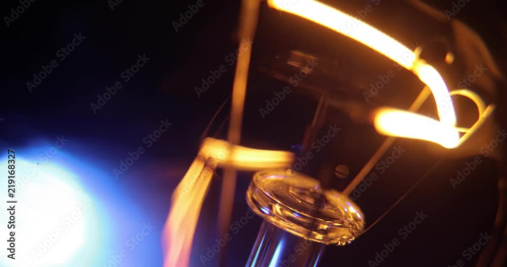Incandescence thread, close up. Real light bulb turning on, flickering and turning off. Macro. Incandescence thread, close up. Real light bulb turning on, flickering and turning off. Macro.