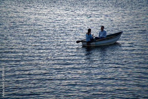 couple rides on boat along the river