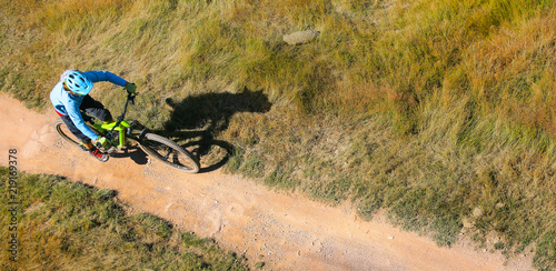Fototapeta Naklejka Na Ścianę i Meble -  Rider top view. Extreme downhill mountain Biking.  Shadow wild dog