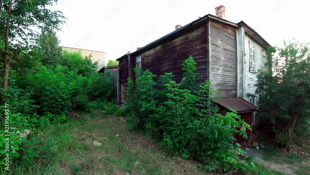 View of an old wooden ramshackle two-story house. View of an old wooden ramshackle two-story house.